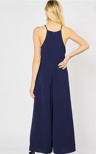 NAVY High-neck jumpsuit featuring self-tie closure detail at waist. Zipper closure at back. Unlined. Non-sheer. Woven. Lightweight.