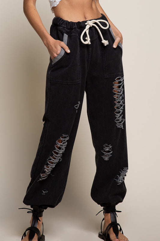 BLACK Distressed jogger pants featuring distressed ripped detailing on body and elastic waist band