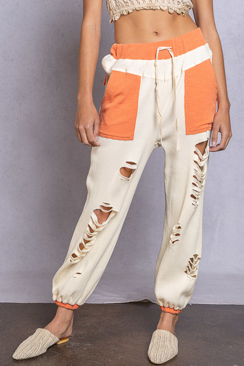 DISTRESSED JOGGERS IN IVORY AND ORANGE