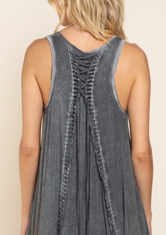 Sleeveless smocking detailed babydoll top with lace-up back tie. IN CHARCOAL