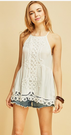 Halter top featuring crochet details at front. Scalloped hem. Keyhole button closure at back. Semi-sheer. Woven. Lightweight. 100%RAYON