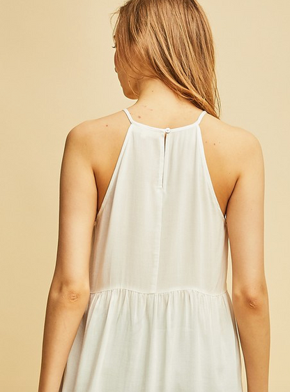 Halter top featuring crochet details at front. Scalloped hem. Keyhole button closure at back. Semi-sheer. Woven. Lightweight. 100%RAYON